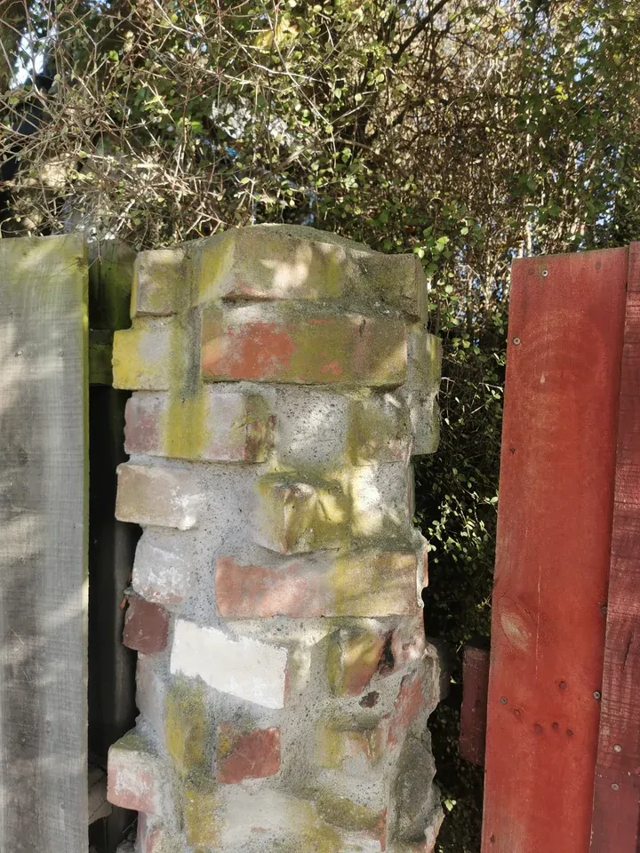 Before: brick pillar with yellowish-green moss and algae on the bricks and mortar.
