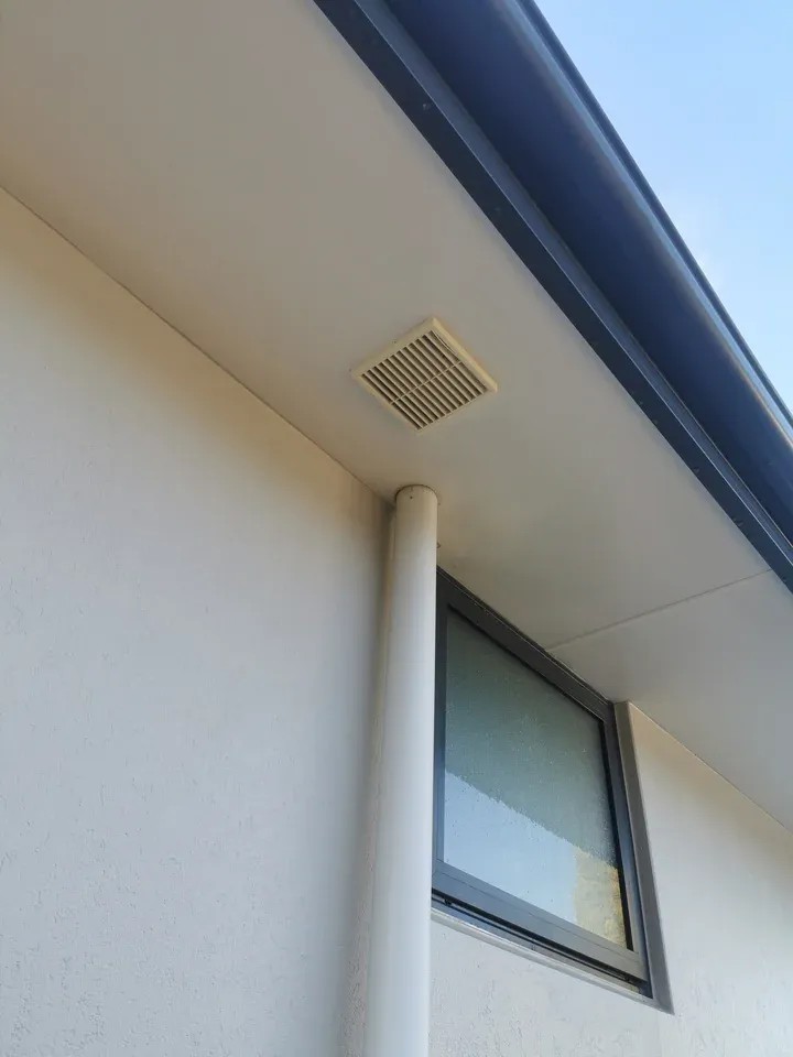 After: the same soffit and vent looking clean and bright following soft washing.