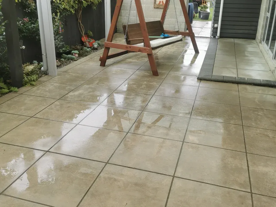 After: the same patio pavers looking lighter and clearer after pressure washing.